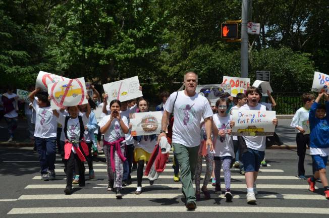 Calhoun School students march in memory of former classmate Cooper Stock, who was killed by a reckless cab driver last January. Photo by Daniel Fitzsimmons.