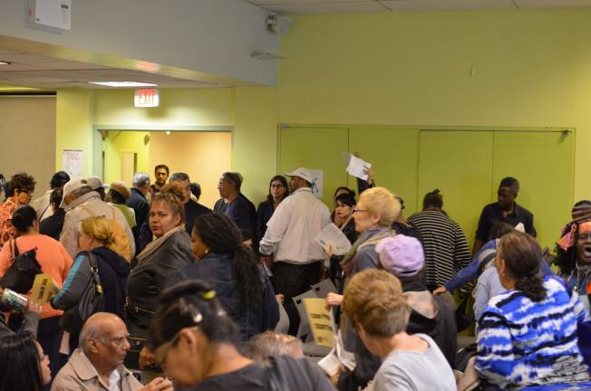 Residents walk out of a meeting with NYCHA officials at the Stanley Isaacs Neighborhood Center on the Upper East Side Wednesday, Oct. 7. Photo by Daniel Fitzsimmons